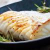 Fillet of baked cod garnished with rosemary