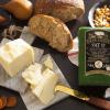 White cheese, cashews and bread on cutting board