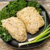 Breaded chicken breasts on black plate