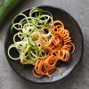 Uncooked Spiralized Sweet Potato and Zucchini on Plate